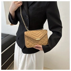 Chic khaki quilted chain bag styled with a black blazer for a sophisticated look