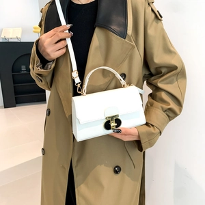 Chic white PU leather handbag with gold buckle styled with a khaki trench coat