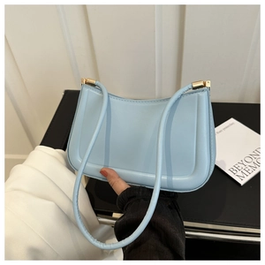 Detailed view of light blue PU leather shoulder bag with smooth texture and gold buckle