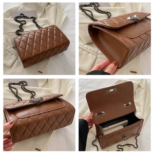 Detail view of brown quilted chain bag showing metal lock and interior storage space