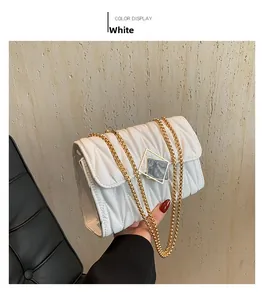 Détail du sac bandoulière blanc à surpiqûres en V avec une chaîne en métal doré