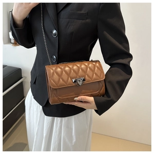 Brown quilted crossbody bag featuring elegant diamond stitching and a gold chain strap