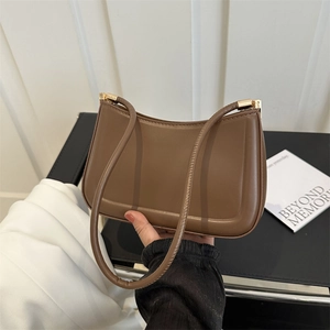 Minimalist brown leather baguette bag with gold hardware for women's daily casual style