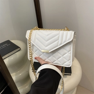 White quilted shoulder bag with gold chain strap and elegant rectangular buckle detail