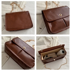 Close-up of brown vintage shoulder bag showing internal capacity for daily essentials