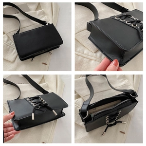 Détail du sac à bandoulière tendance en cuir verni noir avec design à lacets et œillets