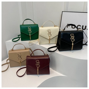 Five assorted crossbody bags in green, white, black, khaki, and burgundy on pedestals