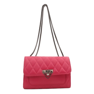 Magenta quilted crossbody bag with diamond stitching and metal chain strap details