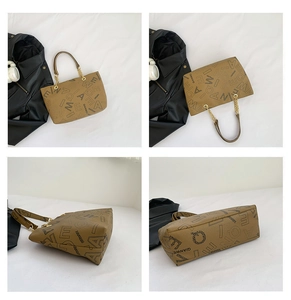 Detail view of khaki leather tote bag featuring logo print and gold chain handles