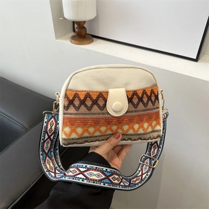 Ethnic canvas crossbody bag with geometric embroidery and wide woven shoulder strap