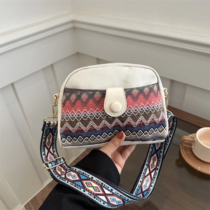 Ethnic style crossbody flap bag with colorful geometric woven pattern and wide shoulder strap