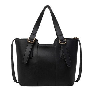 Minimalist black faux leather tote bag with gold hardware and dual handles for commuting