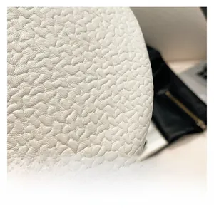 Close-up of white lychee pattern leather texture with high-quality grain for ladies handbag