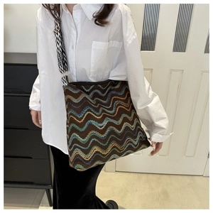 Detail of multi-color wavy knit tote bag with geometric pattern wide shoulder strap