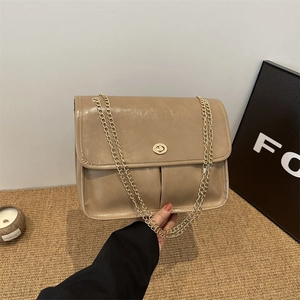 Vintage brown leather shoulder bag with gold chain strap and metal clasp closure