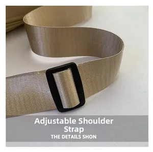 Close-up of adjustable khaki nylon shoulder strap with durable black plastic buckle