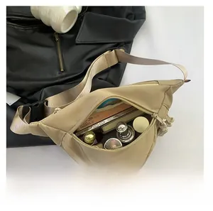 Overhead view of a beige nylon chest bag showing large capacity with cosmetics inside