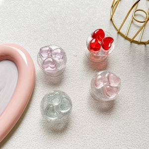 Glittery heart phone grip holders in various colors for stylish desktop support