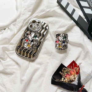 Detail view of silver liquid metal texture phone case with colorful gemstone grip