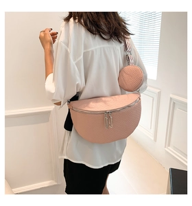 Pink saddle bag with lychee texture and round coin purse on striped strap