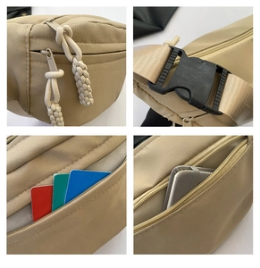Detail view of khaki nylon waist bag showing industrial zippers and internal card slots