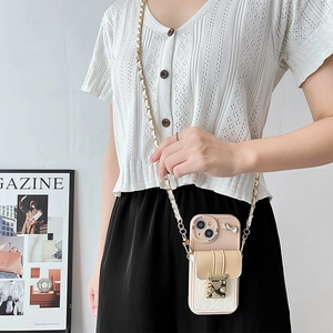 Detailed view of pink crossbody phone case with beige wallet card holder and metal chain strap