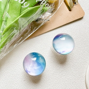 Close-up of starry crystal ball phone grip with blue and purple nebula patterns