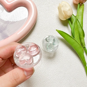 Close-up of glittery heart phone grip holders in pink and mint green colors