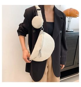 Detail of off-white grain leather saddle bag with wide jacquard strap and coin purse