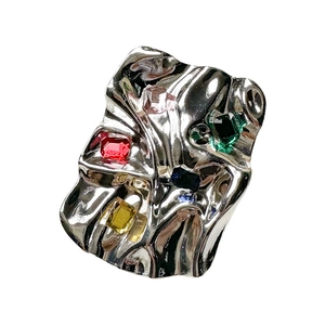 Metallic wrinkled phone socket with colorful gemstones in a liquid metal design
