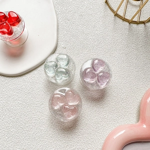 Detail of heart-shaped glitter phone grips in red, purple, pink and green colors