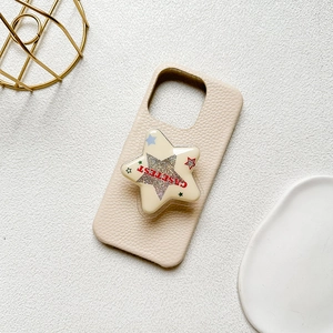 Cream leather phone case with a star-shaped collapsible glitter grip and red text