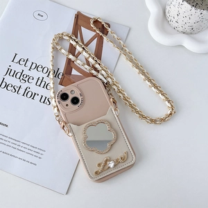 Dettaglio custodia iPhone beige con specchio a fiore, ciondolo love e porta carte