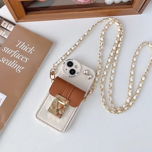 Detail of crossbody phone case for iPhone with mini wallet and gold metal chain strap