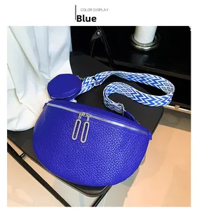 Detail of blue saddle crossbody bag with wide jacquard strap and coin purse