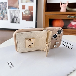 Close-up of beige quilted leather wallet case for iPhone with gold snap and heart charm