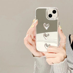 Sleek mirror iPhone case with three 3D silver hearts on a minimalist clear bumper