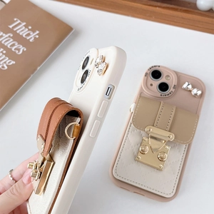 Close-up of leather wallet phone case with gold metal buckle and bow detail for iPhone