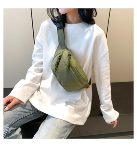 Olive green nylon chest bag details with adjustable strap worn by model in casual style