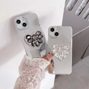 Close-up of sparkling rhinestone heart-shaped grip on a mirror-finish iPhone case