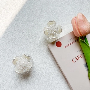 Detail of flower-shaped phone socket with pearl center and creamy white pearlescent finish