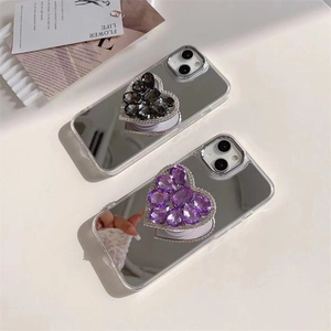 Detailed view of mirror phone cases for iPhone with crystal heart grip in purple and black