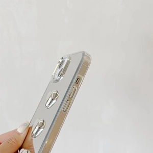 Close-up of iPhone case with silver 3D heart mirror ornaments and side button precision