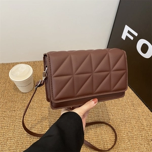 Brown quilted rectangle crossbody bag with geometric stitching and slim shoulder strap