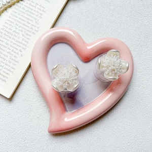 Floral pearl phone grip stand with vintage white petals on heart-shaped ceramic tray