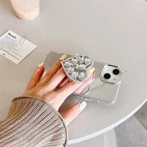 Detail of mirror phone case with luxury heart-shaped rhinestone foldable grip stand
