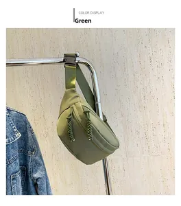 Detail of green waterproof nylon waist bag with adjustable strap and rope zipper pulls