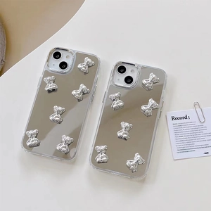 Silver mirror iPhone case with 3D metallic teddy bears on a minimalist background