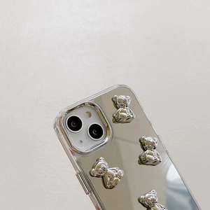 Close-up of iPhone mirror case featuring 3D silver bears and protective camera lens bumper
