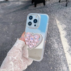 Macro detail of a sparkling pink rhinestone heart socket on a clear mirror iPhone case